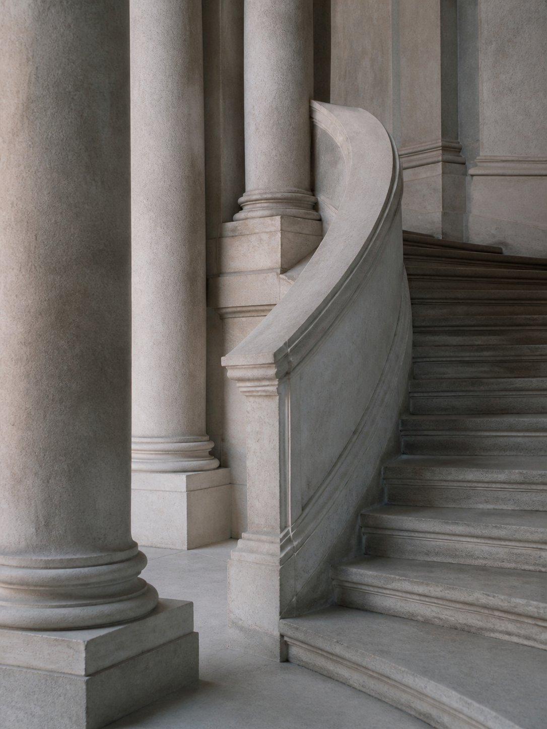 A curved stone staircase winding between columns in soft morning light.